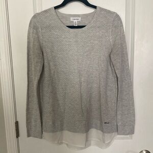 Calvin Klein long sleeve sweater with faux blouse at bottoms hem. Size S.